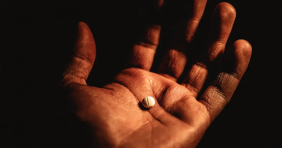Hand holding a pill symbolizing FDA black box warning medication risk