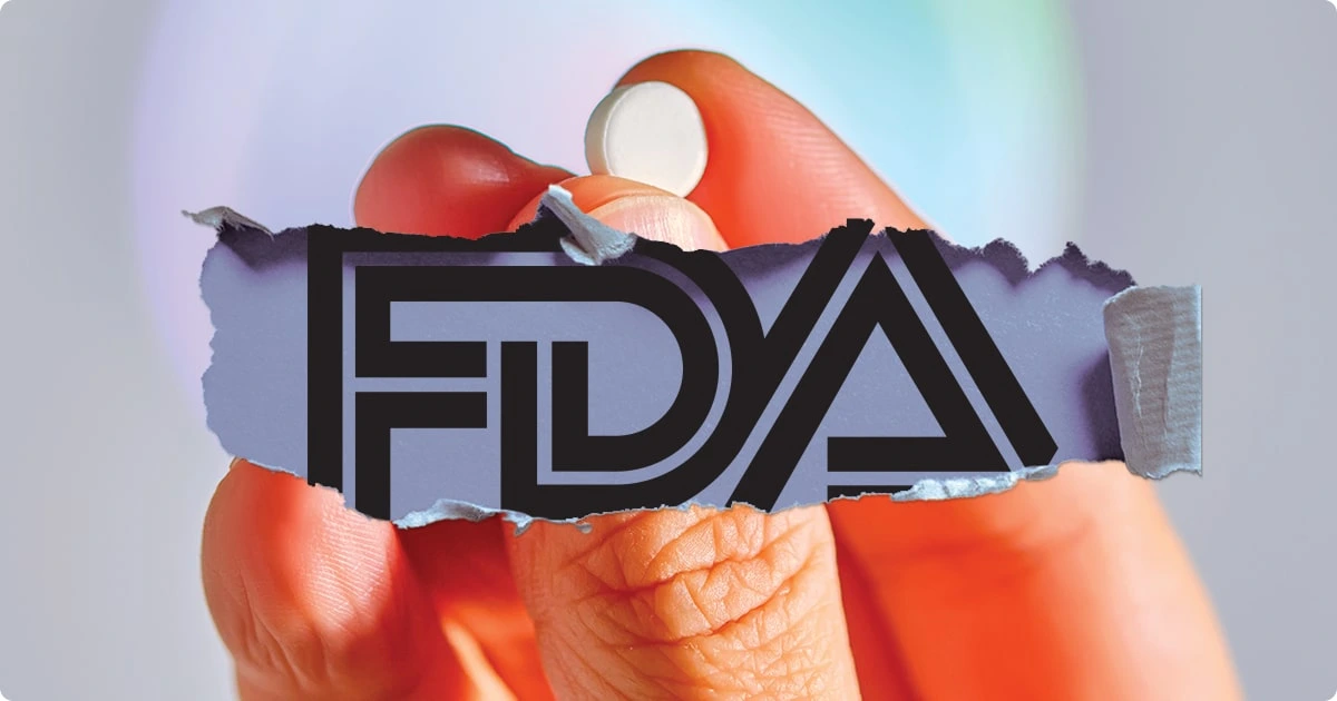 Person holding a pill with FDA logo symbolizing drug safety regulation